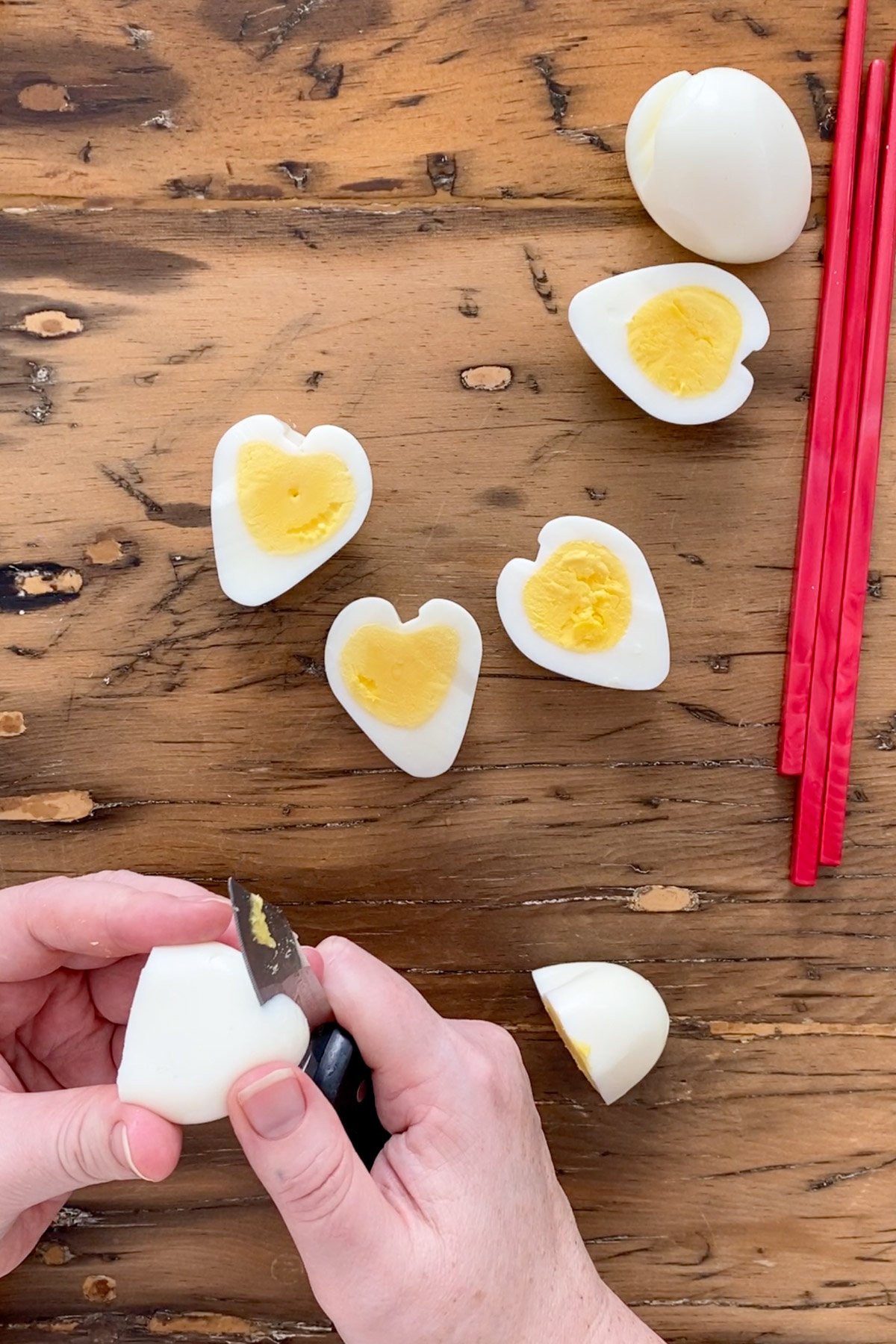 Heart-shaped hard boiled egg sliced in half showing perfect heart shape.