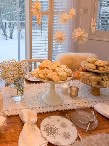 Winter tea party with snowflake decor and menu.