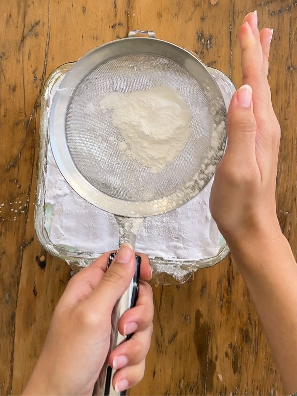 Rainbow marshmallow layers dusted with powdered sugar and cornstarch mixture.