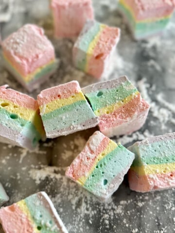 Soft, fluffy homemade rainbow marshmallows with beautiful pastel layers.