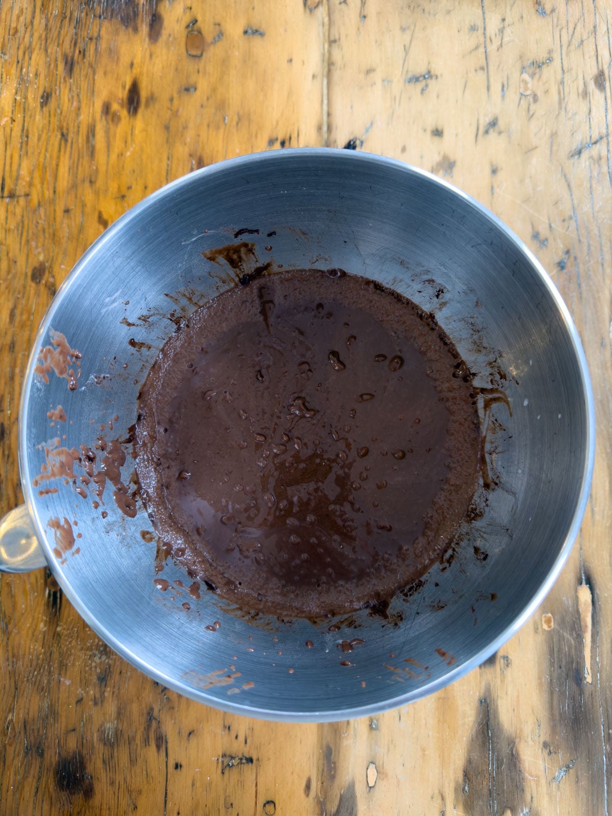 Chocolate instant pudding whisked and thickened in a metal mixing bowl for an Easter trifle.