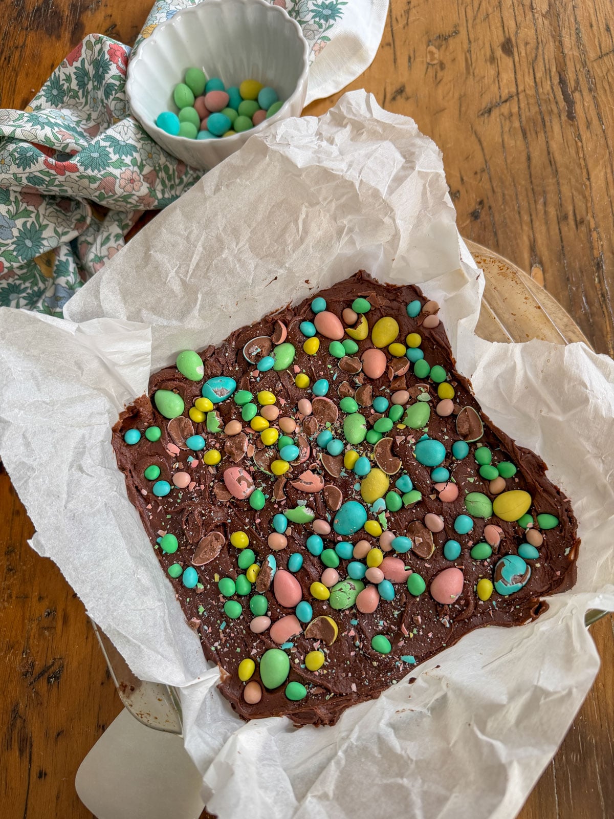 Cadbury mini eggs and micro mini eggs pressed into chocolate frosting on freshly baked brownies.