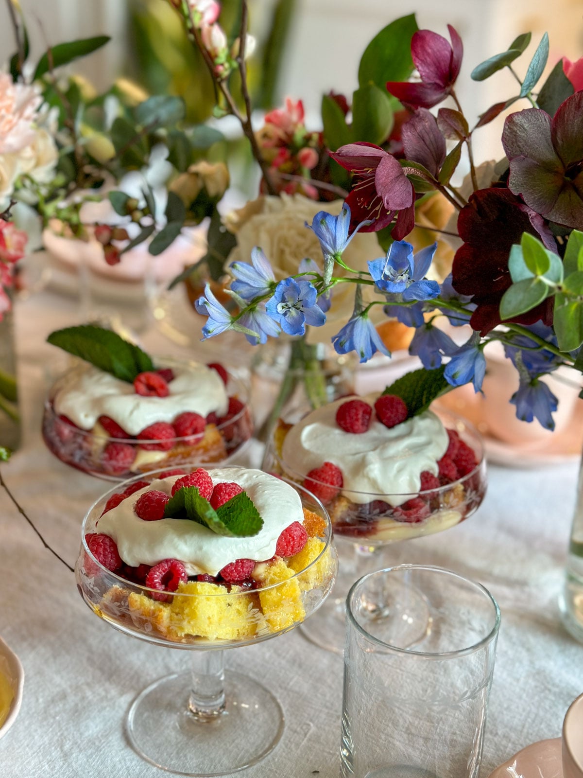 Tea party table with mini trifles and florals.