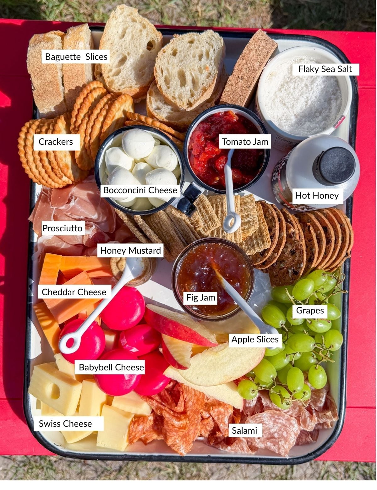 Labeled savory s'mores ingredients including cheeses, meats, jams, and crackers.