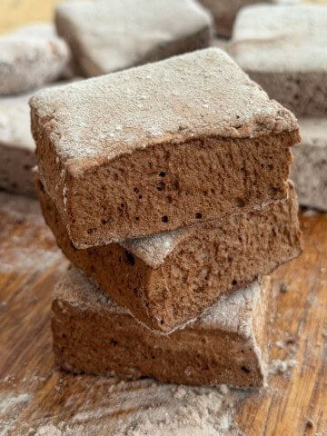 Stack of chocolate marshmallows dusted with cocoa coating.