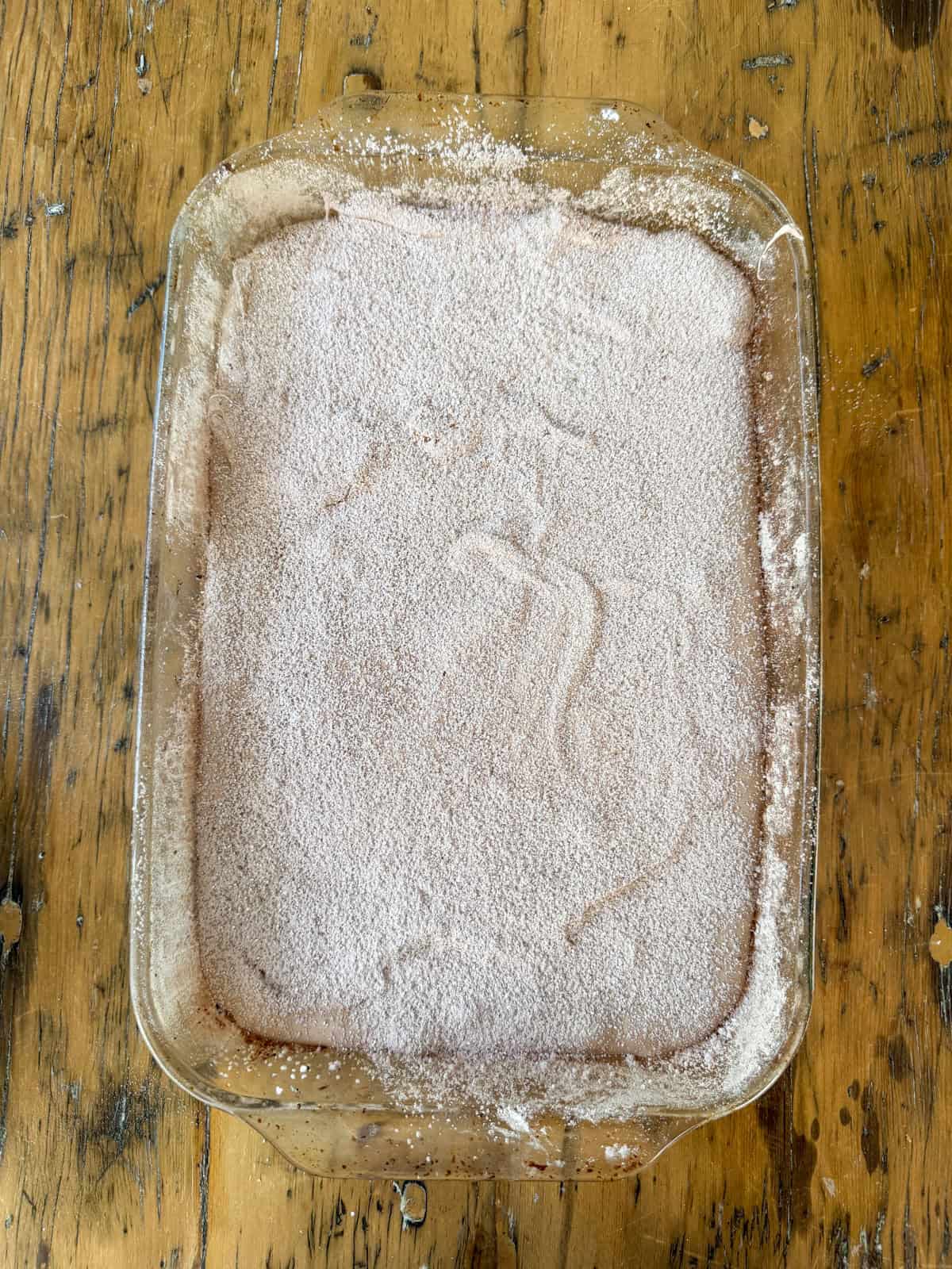 Glass pan dusted with cocoa coating mixture.