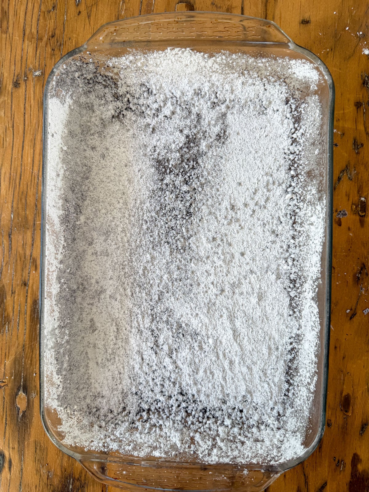 baking pan dusted with cornstarch, powdered sugar, and Oreo crumb coating.