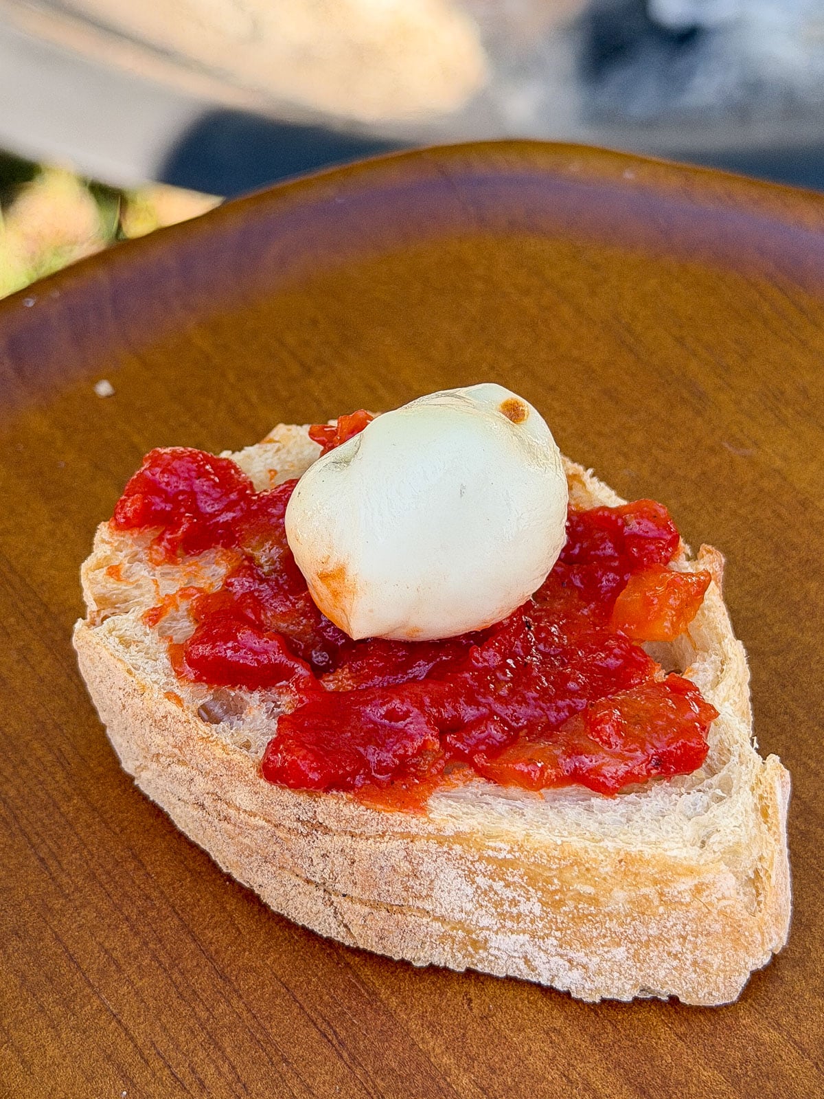 Bocconcini and tomato jam on toasted baguette slice.