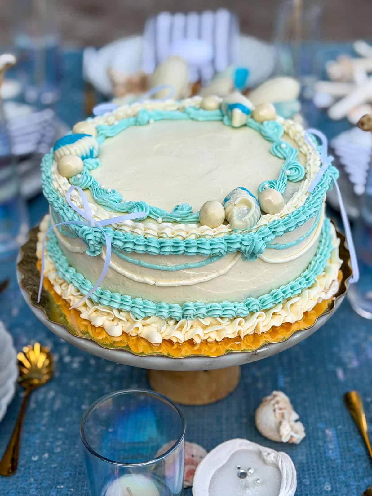 Mermaid cake with turquoise frosting and edible seashells.