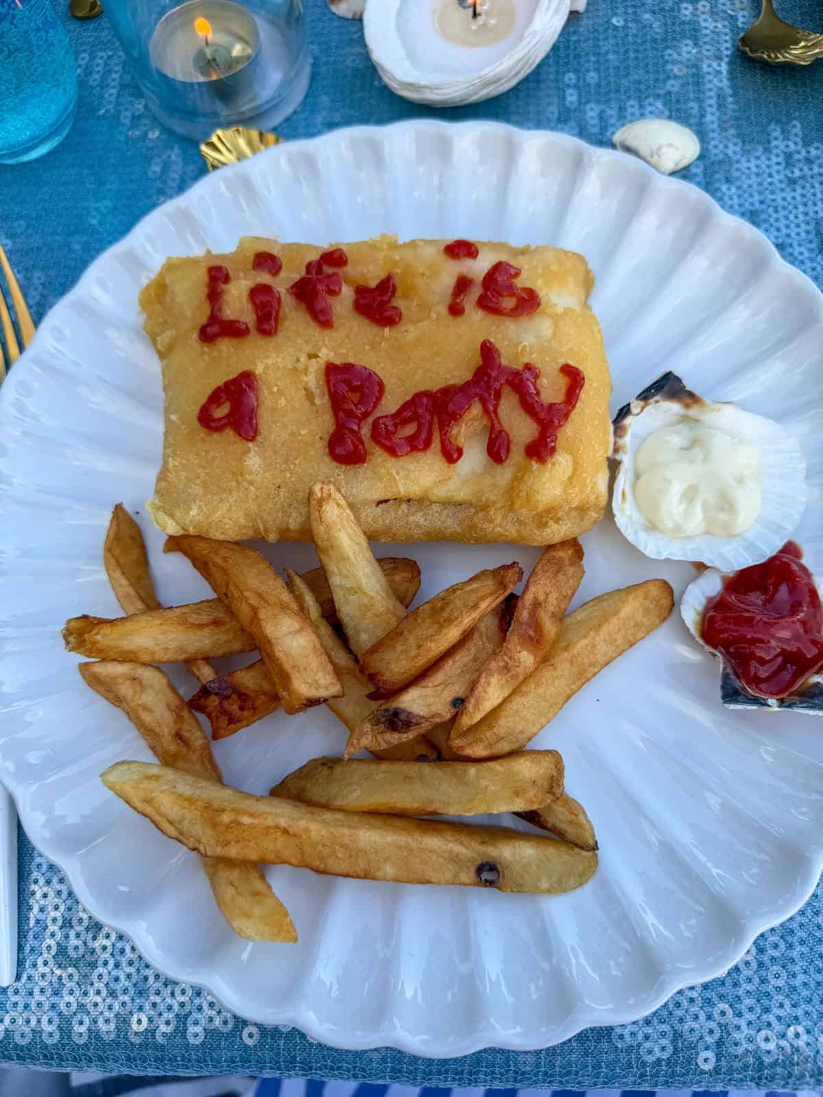 Fish and chips plate with Life is a Party written in ketchup.
