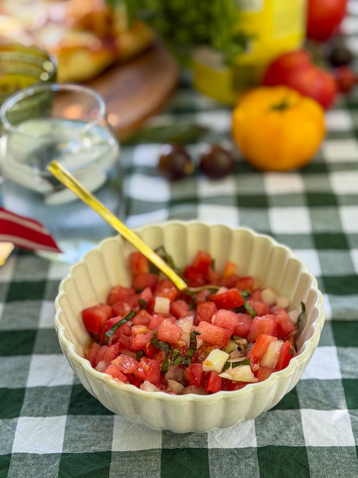 Bowl of fresh tomato bruschetta topping with basil.