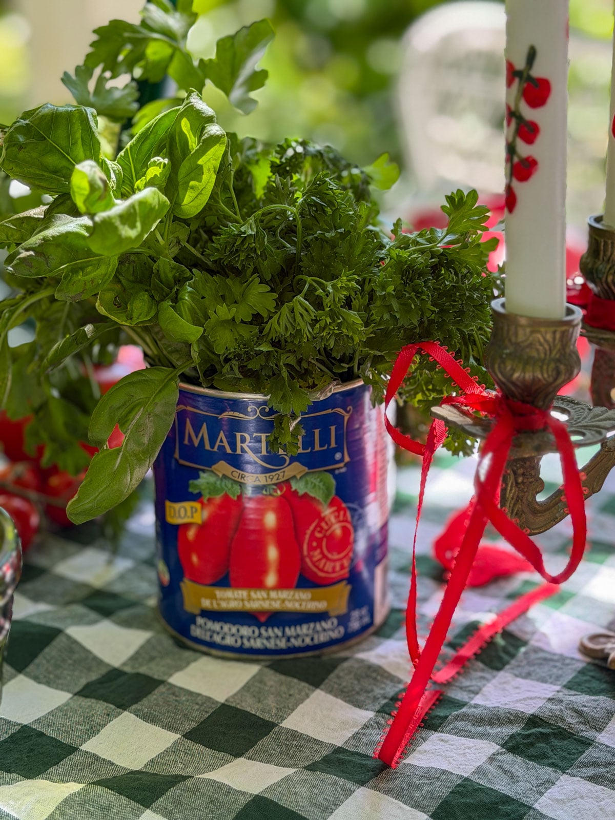 Fresh herbs in upcycled Italian tomato can vase.