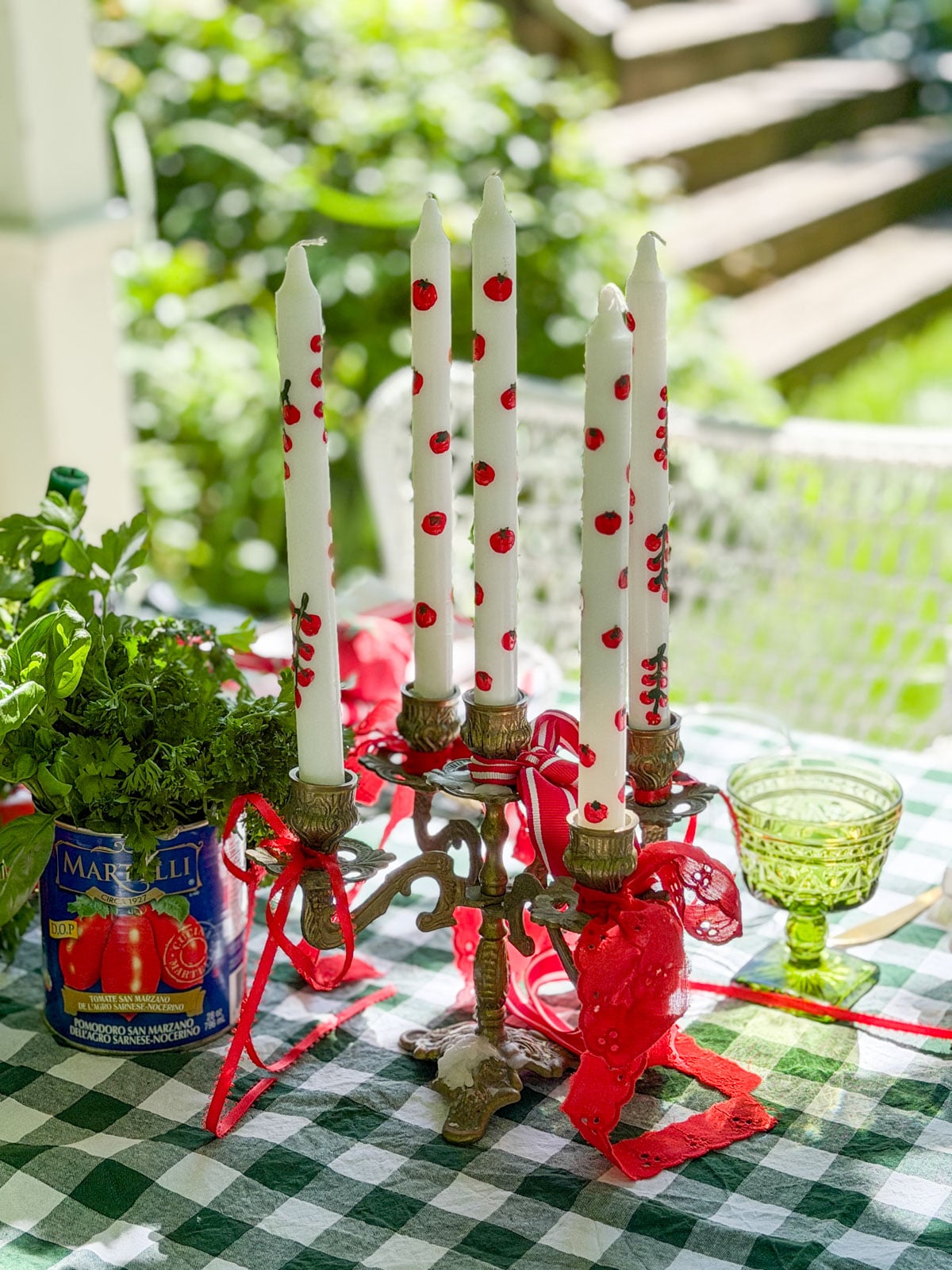 Brass candelabra with hand painted tomato taper candles.