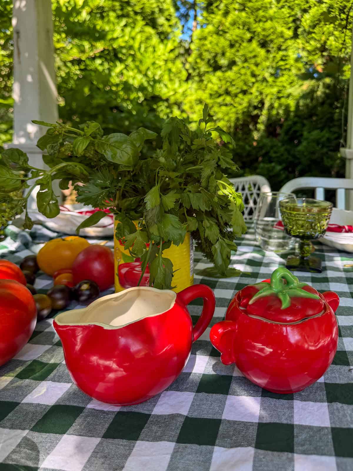 Vintage tomato shaped cream and sugar set on table.