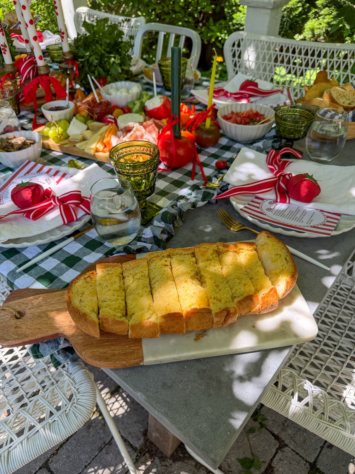 Sliced garlic bread on wooden cutting board.