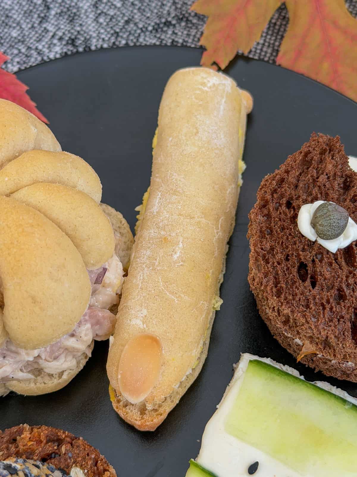 Witch finger sandwich made with a long egg salad roll and an almond fingernail.